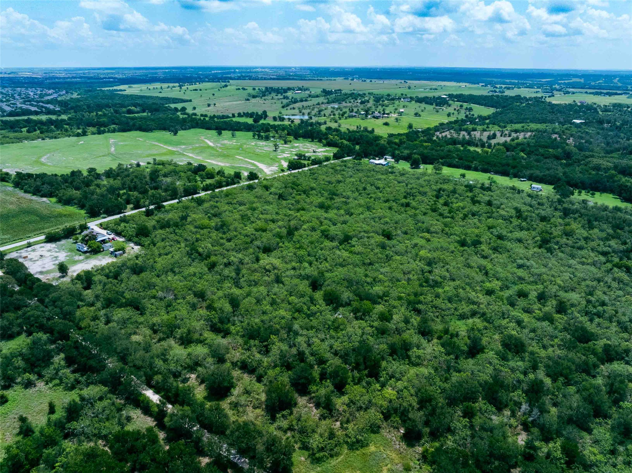 17715 Albert Voelker Road Elgin, TX 78621 - Photo 17 of 19 an aerial view of residential houses with outdoor space and trees