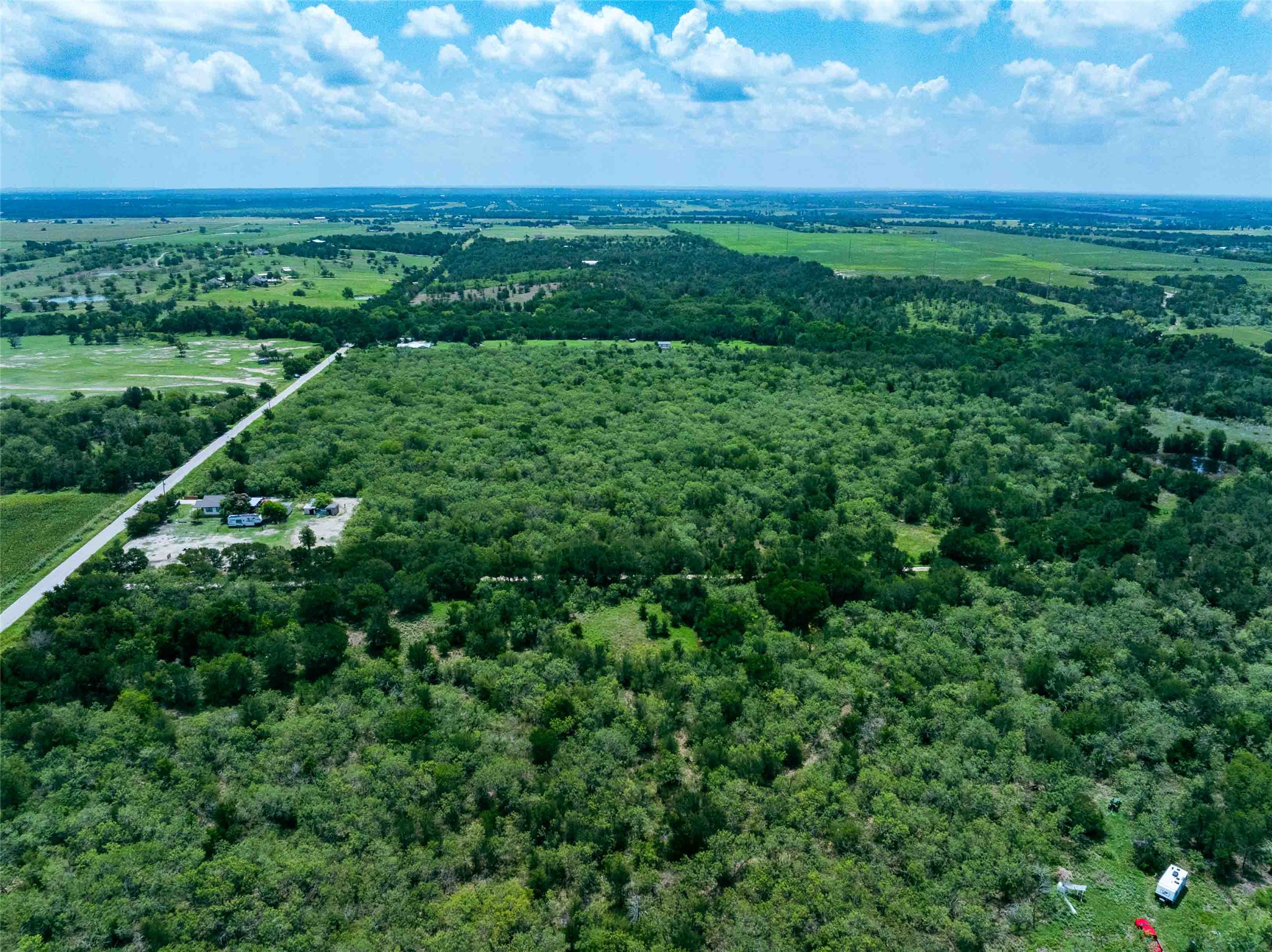 17715 Albert Voelker Road Elgin, TX 78621 - Photo 18 of 19 a view of a green field with lots of bushes