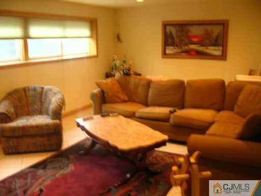 47 Wilk Road Edison, NJ 08837 - Photo 6 of 8 a blue couch sitting next to a blue wall