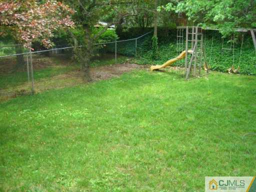 47 Wilk Road Edison, NJ 08837 - Photo 8 of 8 a view of a wooden deck and a park