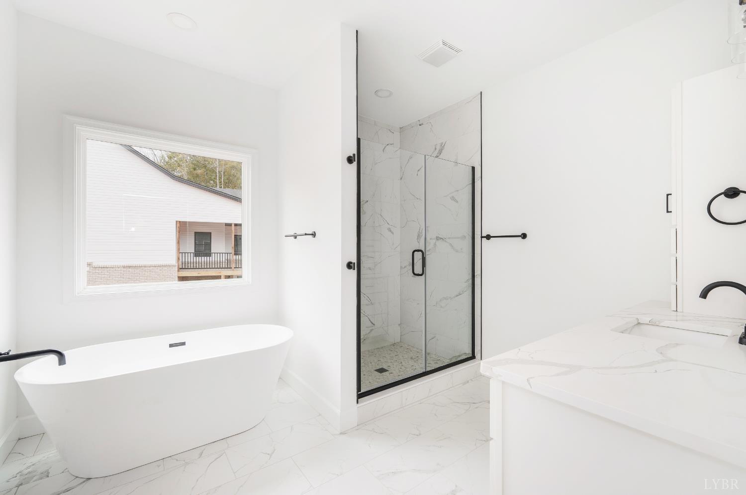 11218 Leesville Road Evington, VA 24550 - Photo 19 of 54 a bathroom with a tub and a shower