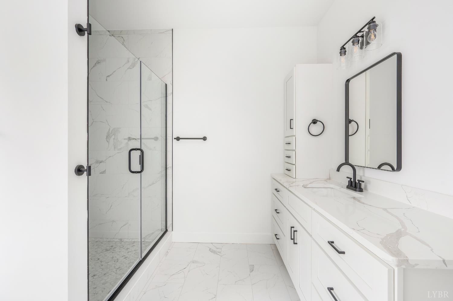 11218 Leesville Road Evington, VA 24550 - Photo 20 of 54 a bathroom with a double vanity sink mirror and shower