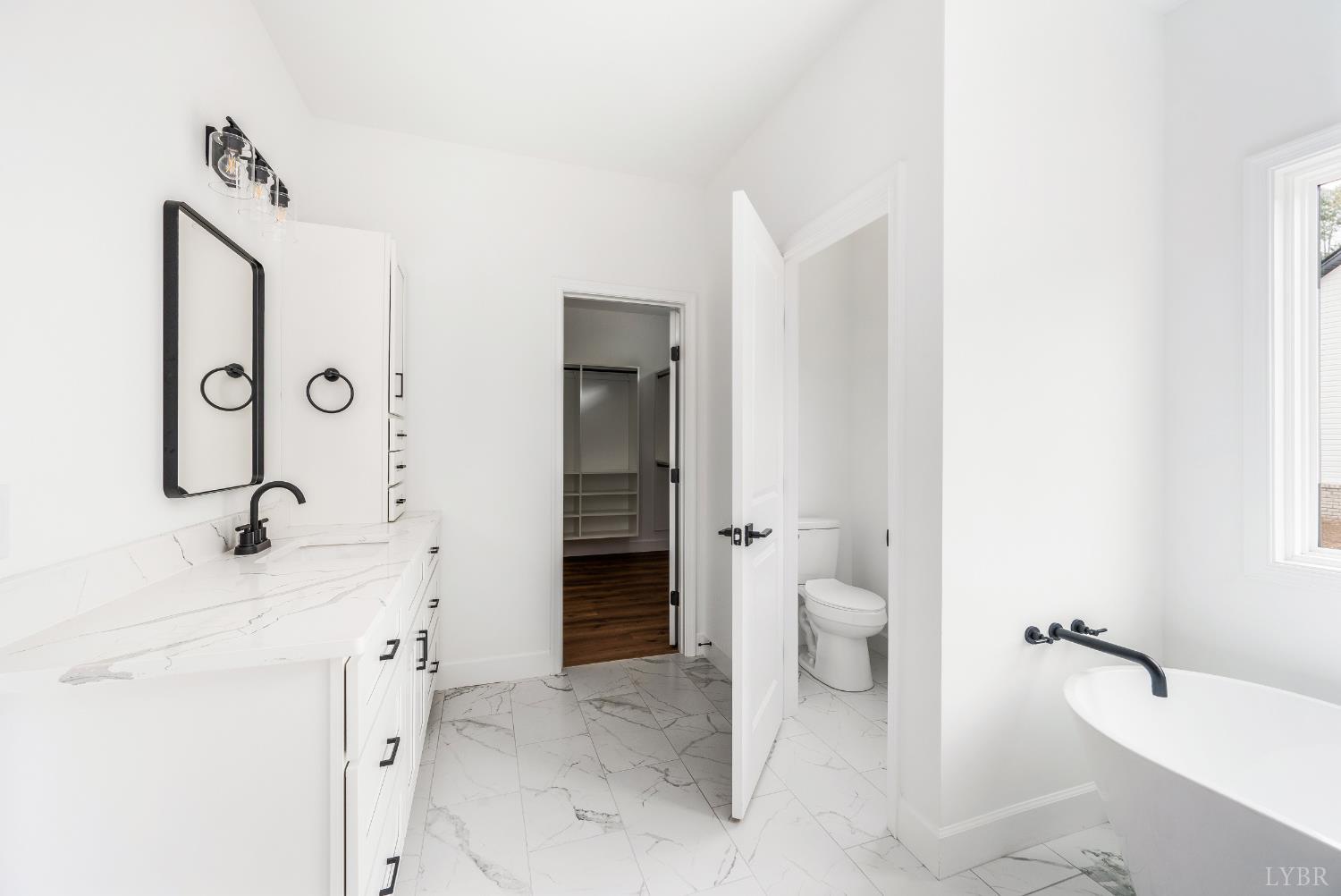 11218 Leesville Road Evington, VA 24550 - Photo 23 of 54 a bathroom with a granite countertop sink toilet and shower