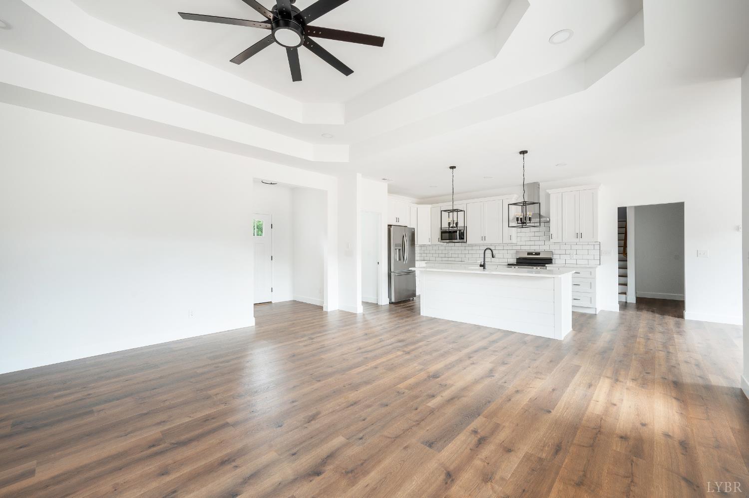 11218 Leesville Road Evington, VA 24550 - Photo 31 of 54 a view of a kitchen with wooden floor and a ceiling fan