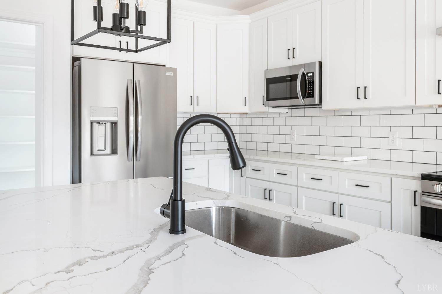 11218 Leesville Road Evington, VA 24550 - Photo 6 of 54 a kitchen with stainless steel appliances a sink a stove and microwave