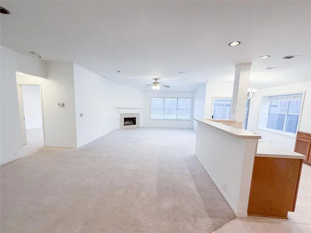 a view of a kitchen with refrigerator and windows