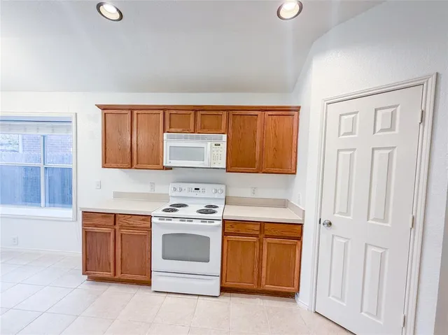 a kitchen with a stove top oven sink and cabinets