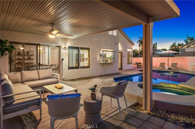 a living room with furniture and a floor to ceiling window