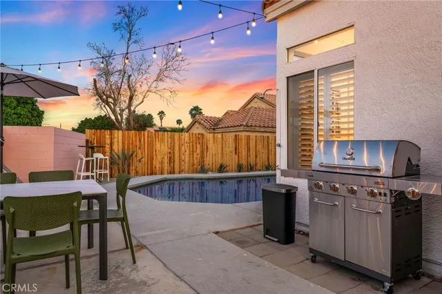 a patio with a table and chairs