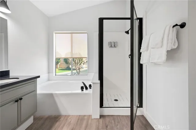 a large bed sitting in a bedroom with a white comforter and pillows