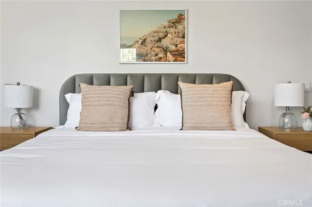 a bedroom with a bed and a painting on the wall