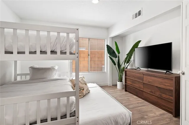 a bathroom with a granite countertop toilet a sink and a mirror
