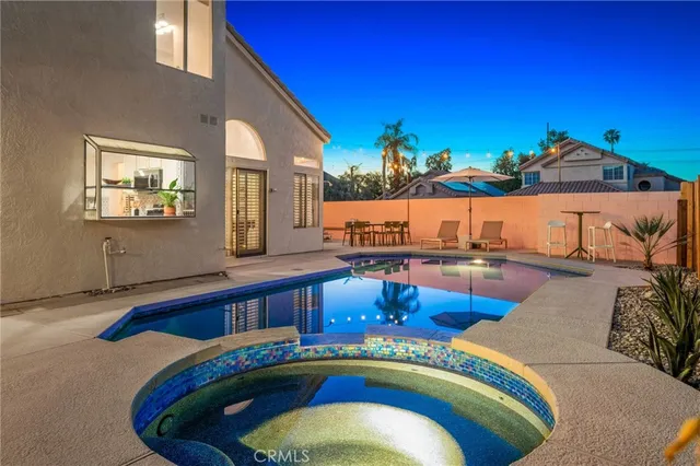 a swimming pool with outdoor seating