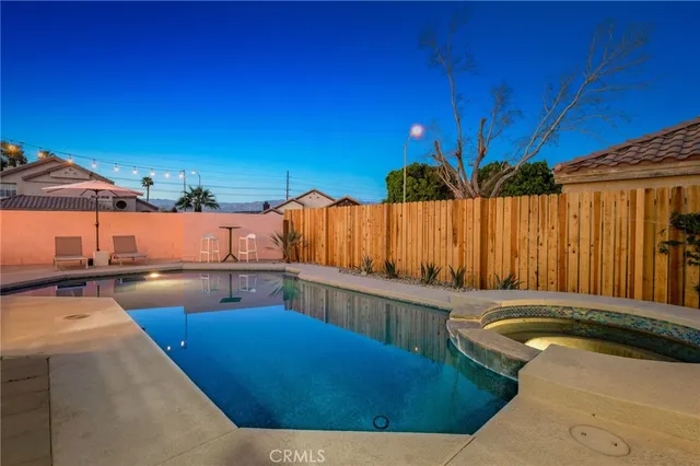 a view of a swimming pool with chairs