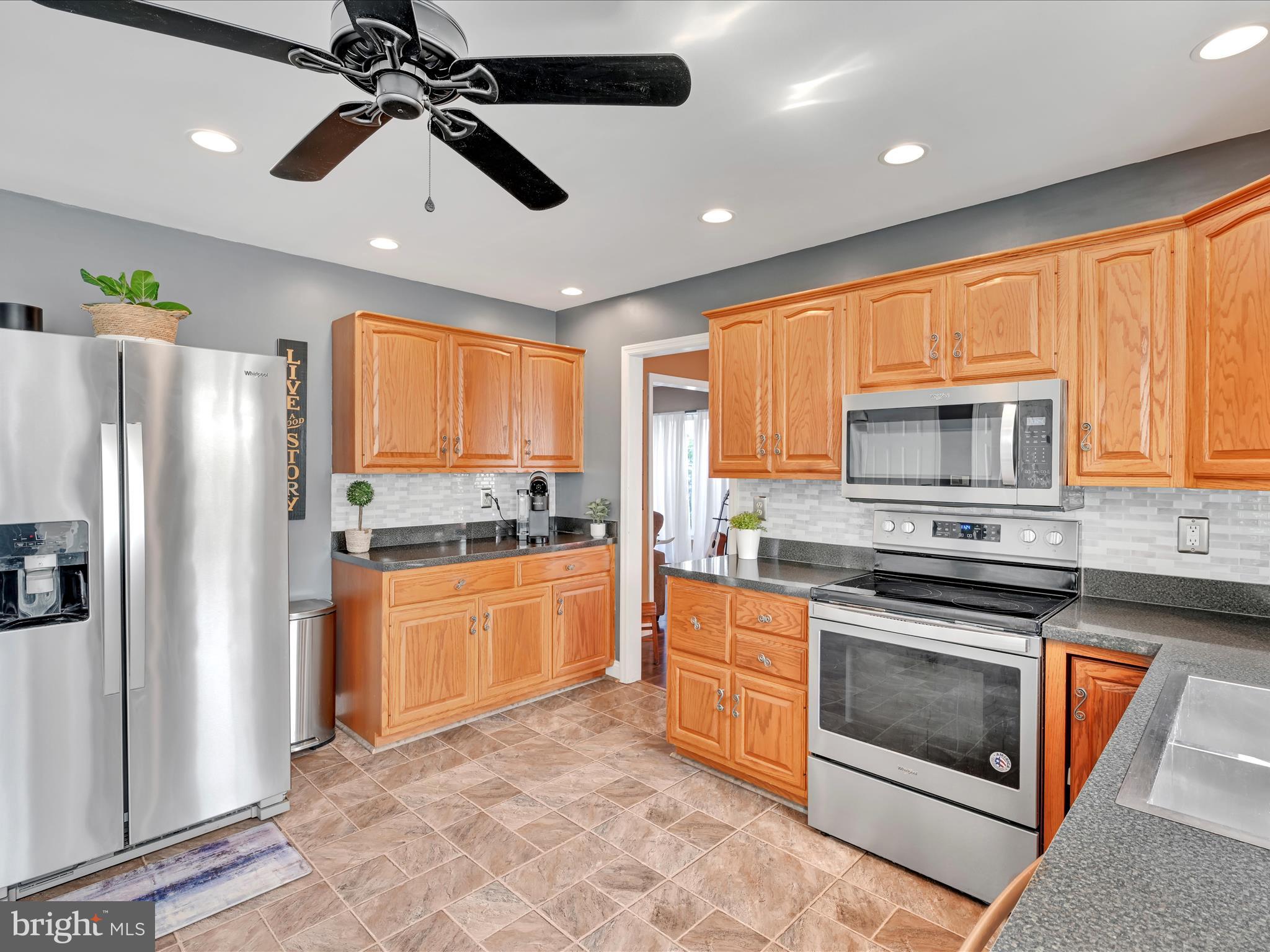 27 Flint Ridge Drive Reading, PA 19607 - Photo 9 of 31 a kitchen with stainless steel appliances granite countertop a stove a refrigerator and a stove top oven