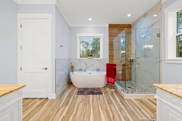 a spacious bathroom with a tub and shower