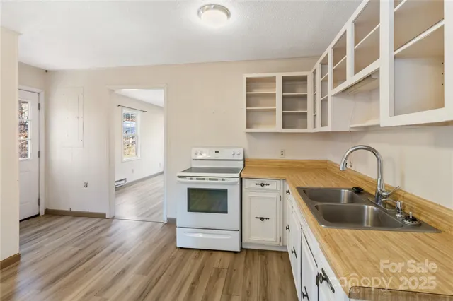 a kitchen with a stove a sink and a refrigerator