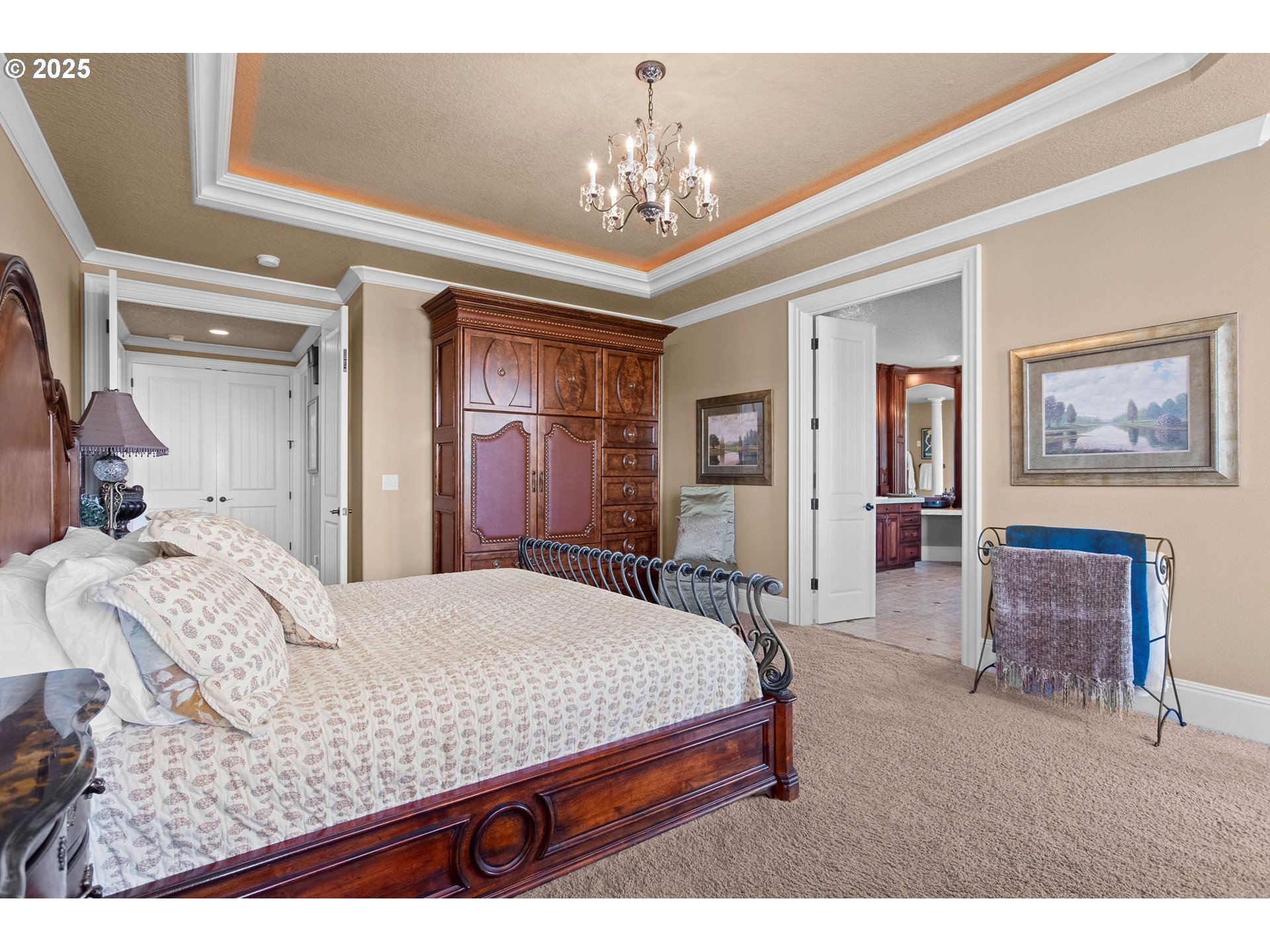 8438 Cascade Highway Northeast Silverton, OR 97381 - Photo 19 of 48 a bedroom with a large bed a chandelier and dresser