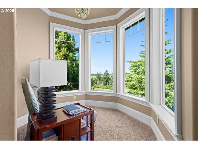 a view of a dining room with furniture and a chandelier