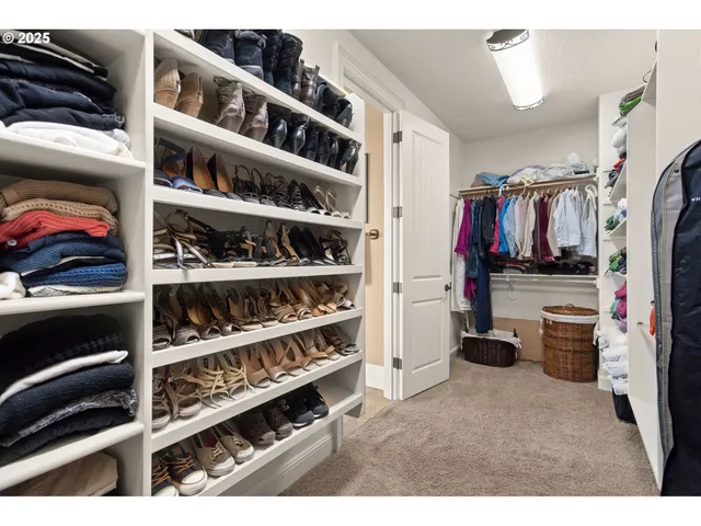a bedroom with a bed and a mirror on dresser