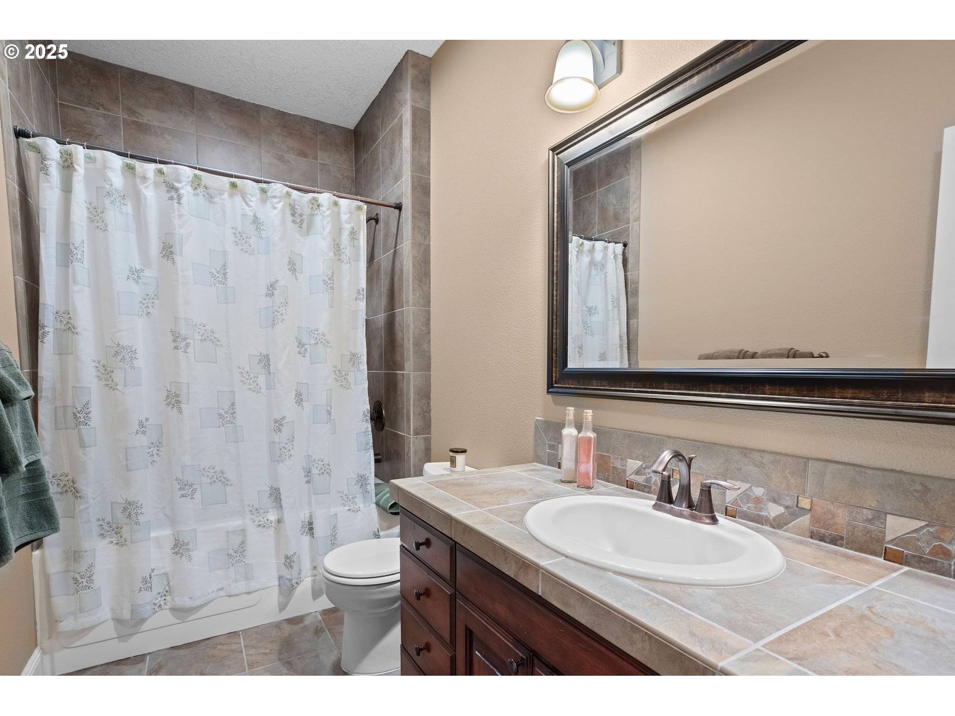 8438 Cascade Highway Northeast Silverton, OR 97381 - Photo 30 of 48 a bathroom with a granite countertop sink toilet a mirror and shower