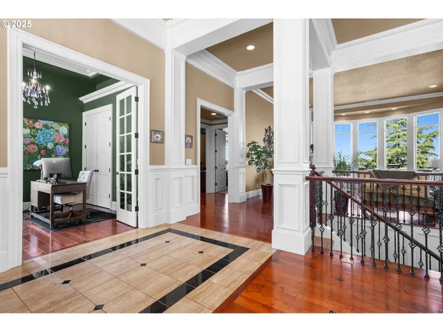 a dining room with furniture a chandelier and wooden floor
