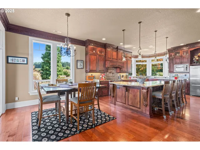 a view of a dining room with furniture wooden floor and chandelier