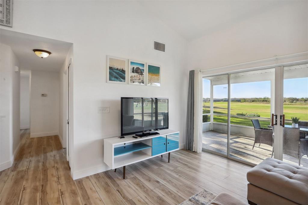 312 Eagle Ridge Drive, Unit 312 Davenport, FL 33837 - Photo 12 of 39 a living room with furniture and a flat screen tv