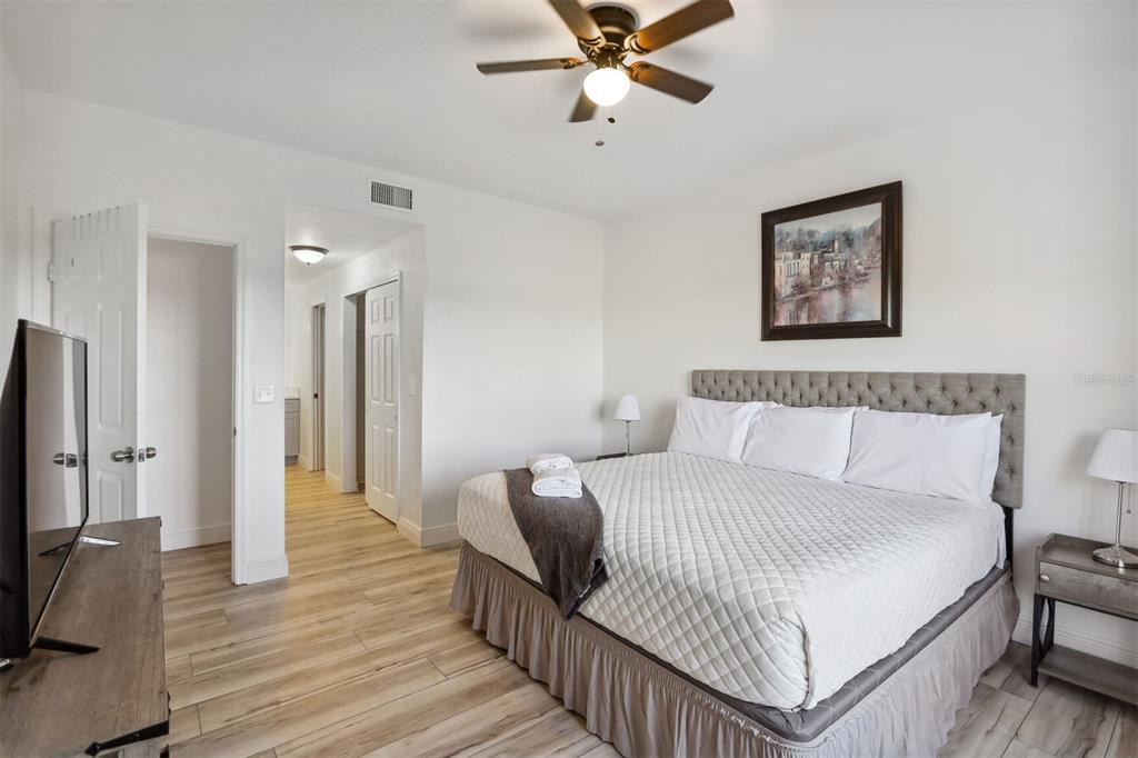 312 Eagle Ridge Drive, Unit 312 Davenport, FL 33837 - Photo 18 of 39 a bedroom with a bed and a flat screen tv