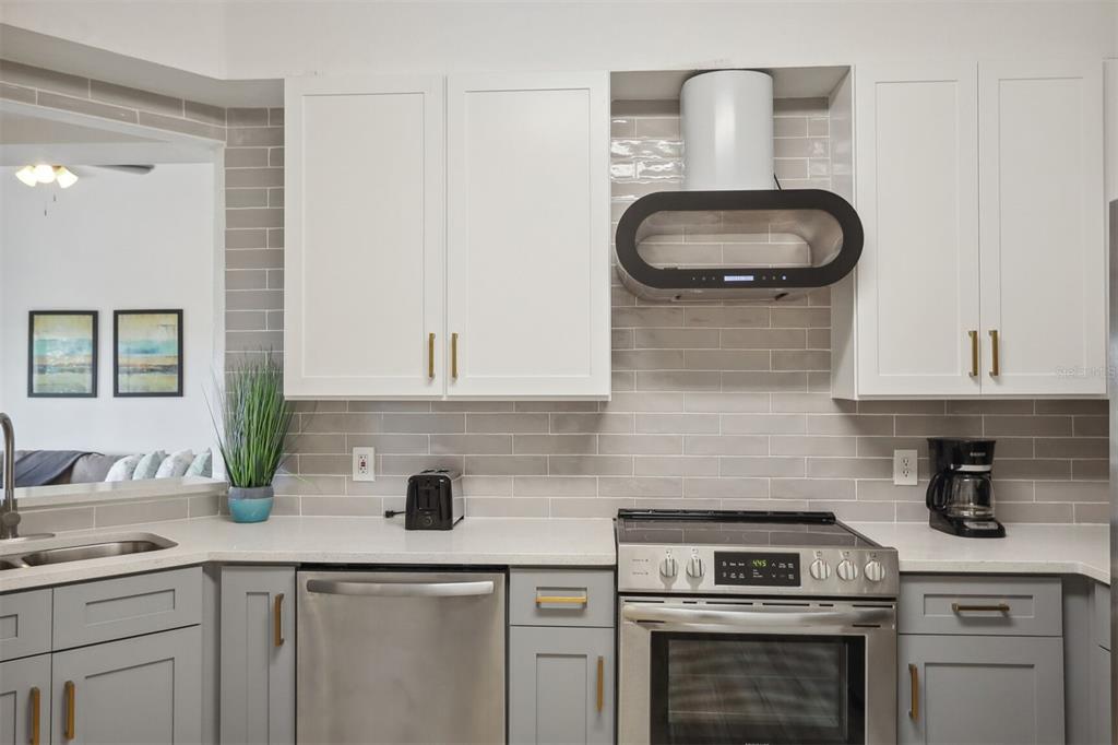 312 Eagle Ridge Drive, Unit 312 Davenport, FL 33837 - Photo 2 of 39 a kitchen with a sink stove and cabinets