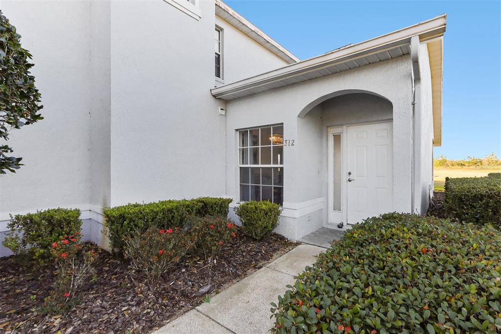 312 Eagle Ridge Drive, Unit 312 Davenport, FL 33837 - Photo 29 of 39 a front view of a house with garden