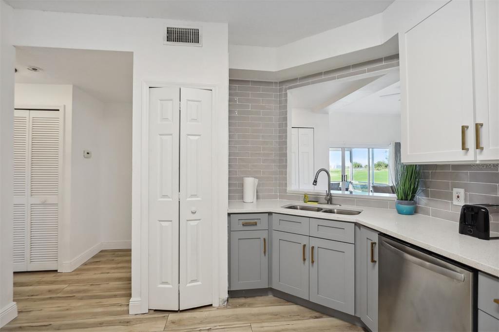 312 Eagle Ridge Drive, Unit 312 Davenport, FL 33837 - Photo 34 of 39 a kitchen with a sink cabinets and wooden floor