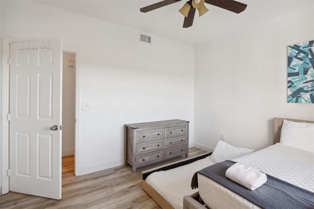 312 Eagle Ridge Drive, Unit 312 Davenport, FL 33837 - Photo 5 of 39 a bedroom with a bed and wooden floor