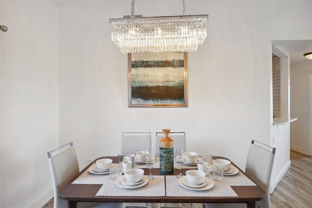312 Eagle Ridge Drive, Unit 312 Davenport, FL 33837 - Photo 6 of 39 a view of a dining room with furniture and wooden floor