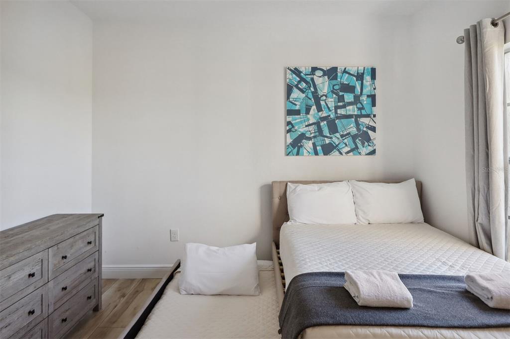 312 Eagle Ridge Drive, Unit 312 Davenport, FL 33837 - Photo 8 of 39 a bedroom with a bed and a window