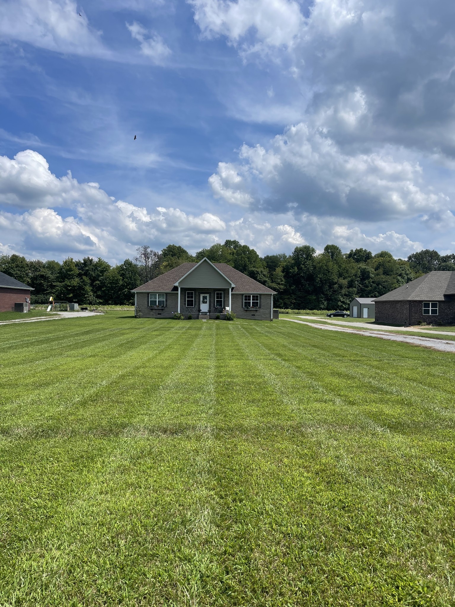 81 Butler Road Lafayette, TN 37083 - Photo 1 of 11 a view of a green field with house in the background