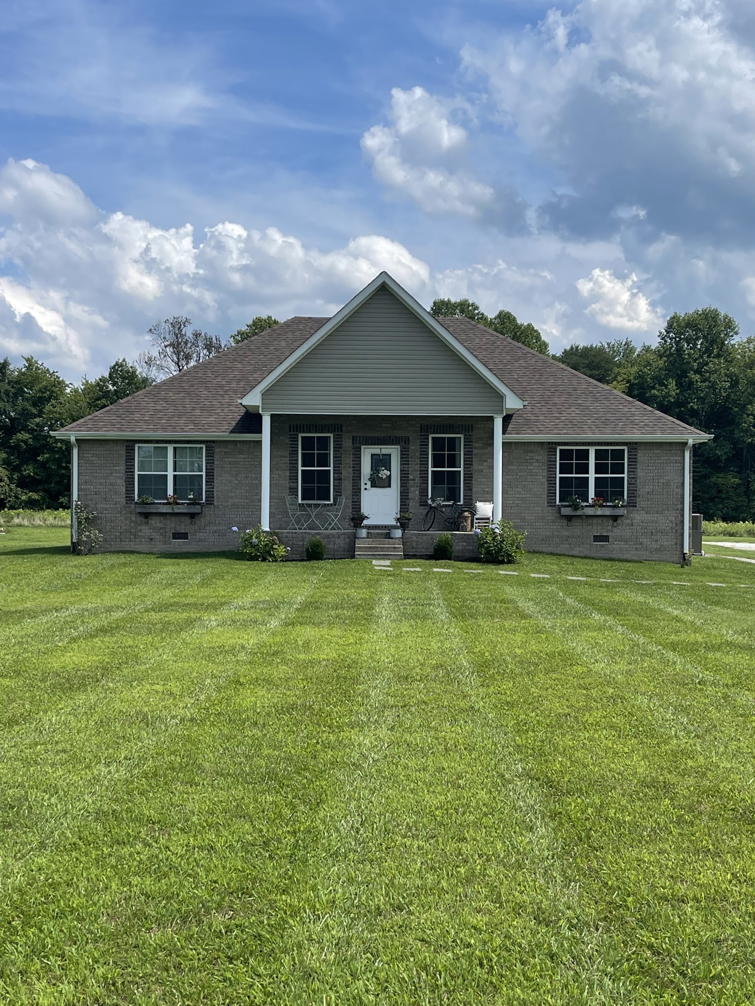 81 Butler Road Lafayette, TN 37083 - Photo 8 of 11 a front view of a house with a garden