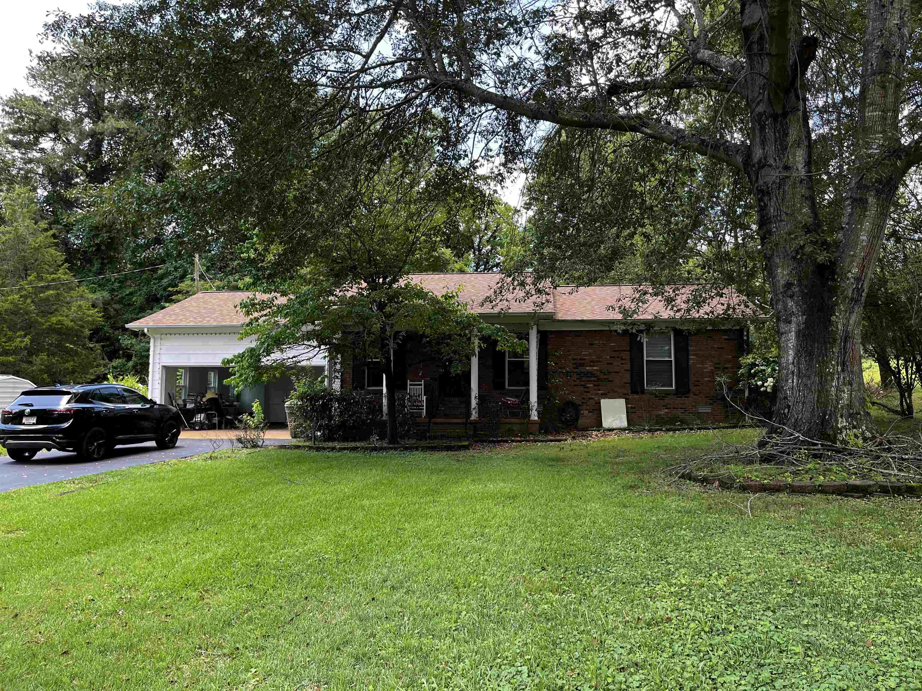 a view of a house with a yard and sitting area