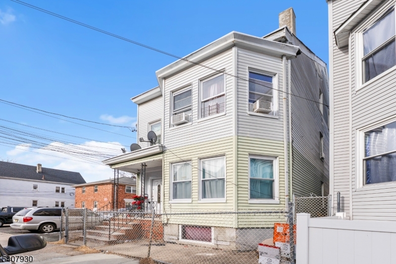183 Walnut Street Paterson, NJ 07522 - Photo 1 of 37 a front view of a house with a garage
