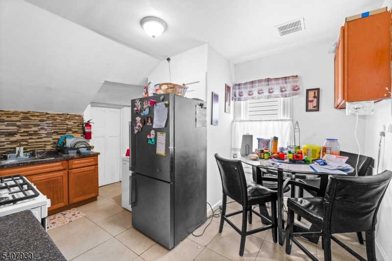183 Walnut Street Paterson, NJ 07522 - Photo 11 of 37 a kitchen with stainless steel appliances granite countertop a refrigerator and a sink