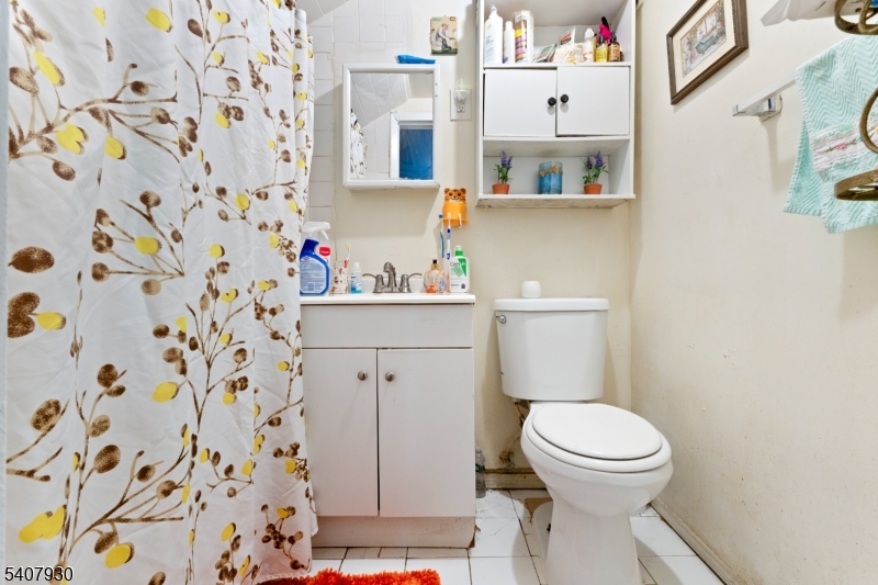 183 Walnut Street Paterson, NJ 07522 - Photo 16 of 37 a white toilet sitting next to a bathroom sink