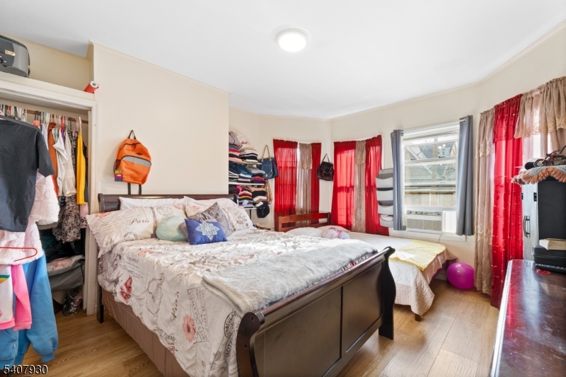 183 Walnut Street Paterson, NJ 07522 - Photo 20 of 37 a bedroom with a bed and a closet
