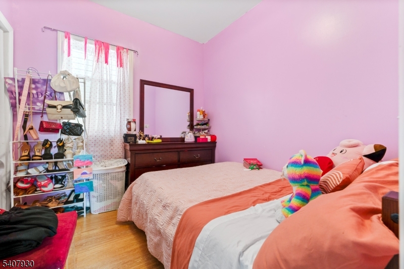 183 Walnut Street Paterson, NJ 07522 - Photo 21 of 37 a bedroom with a bed and a window