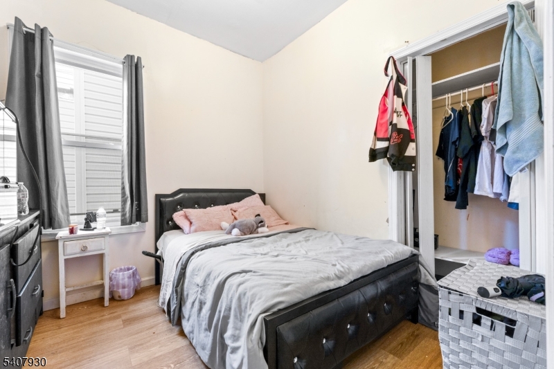 183 Walnut Street Paterson, NJ 07522 - Photo 22 of 37 a bedroom with a bed and a window