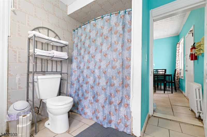 183 Walnut Street Paterson, NJ 07522 - Photo 25 of 37 a bathroom with a toilet and a shower
