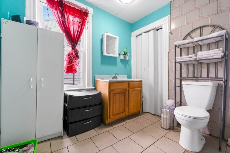 183 Walnut Street Paterson, NJ 07522 - Photo 26 of 37 a bathroom with a sink toilet and a mirror