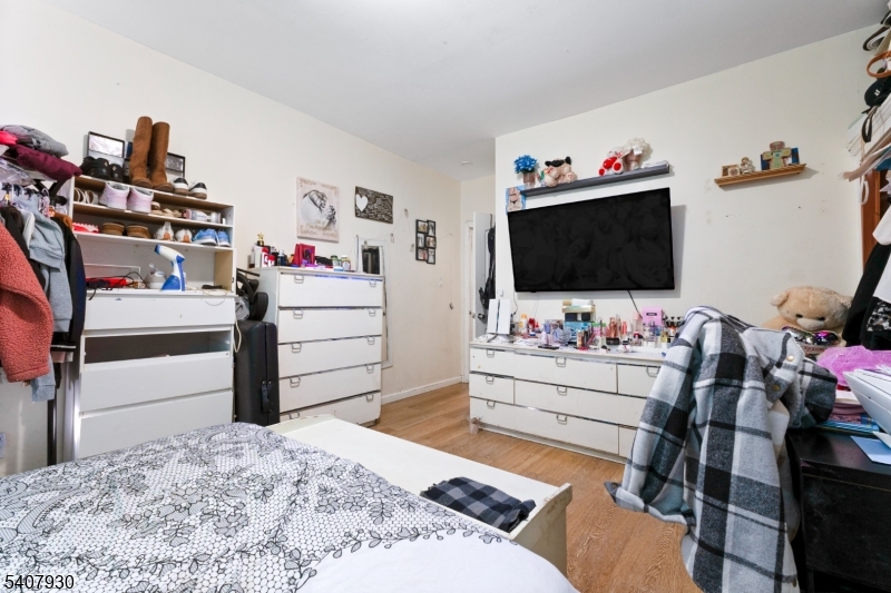 183 Walnut Street Paterson, NJ 07522 - Photo 29 of 37 a bedroom with a bed and flat screen tv