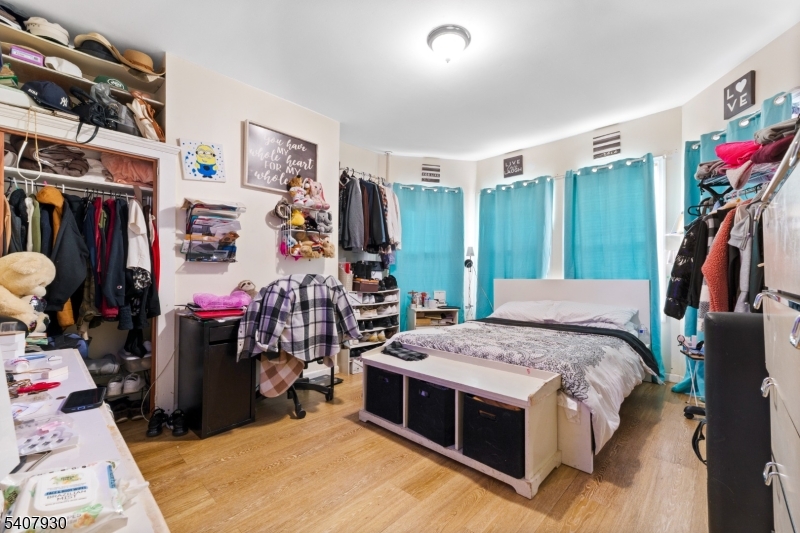 183 Walnut Street Paterson, NJ 07522 - Photo 30 of 37 a bedroom with bed and a large mirror