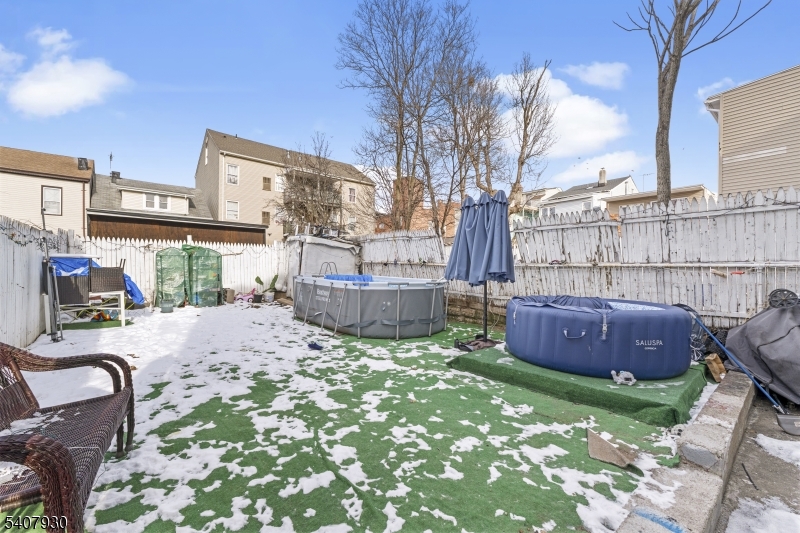 183 Walnut Street Paterson, NJ 07522 - Photo 8 of 37 a view of backyard with barbeque grill and outdoor seating