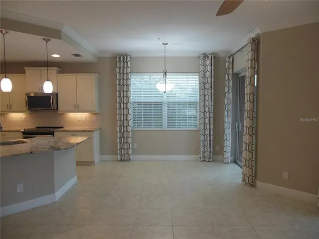 a kitchen with kitchen island a sink stainless steel appliances and cabinets